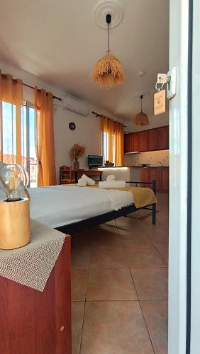 a bedroom with a large bed in a room at Ammoudeli Coastal Escape in Plomari