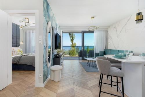 a kitchen and living room with a table and chairs at Sea View Baltic Lux Hevenia in Rewal