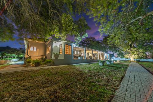 a house with a lawn in front of it at Room 4 - LEO Sky Guest House in Simondium