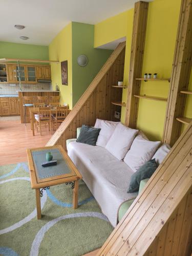 a living room with a couch and a table at Hills View Apartment in Donovaly