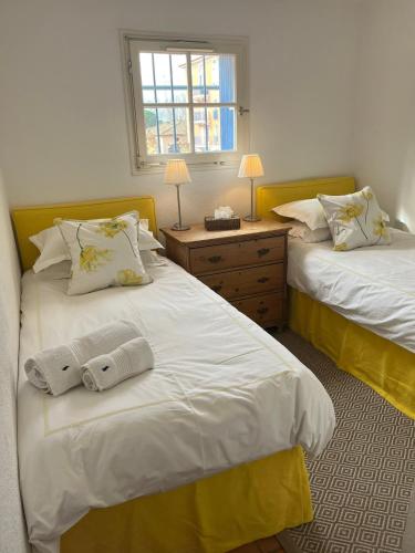 a bedroom with two beds and a window at Charming apartment in Port Grimaud in Grimaud