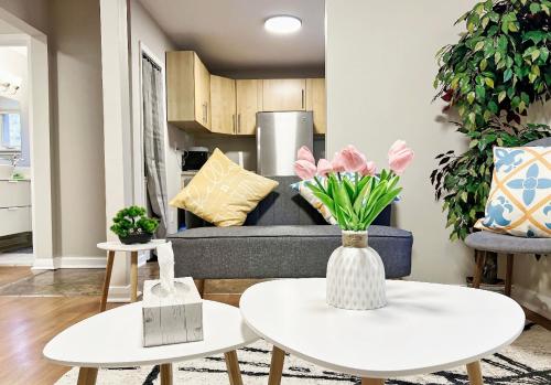 a living room with two tables and a couch at Private Budget Deluxe Room- Next to GO STATION-FREE PARKING-WIFI- in Richmond Hill