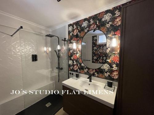 a bathroom with a sink and a mirror at Jo's Studio Flat Limens in Cangas de Morrazo