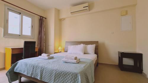 a bedroom with a bed with towels on it at STAY Sunrise Beach Apt 2 in Protaras