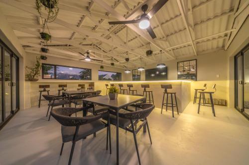 a restaurant with tables and chairs in a room at Room 5 - LEO Sky Guest House in Simondium
