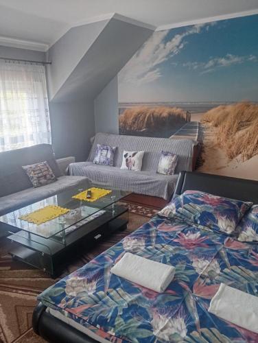 a living room with a bed and a couch at POKOJE GOŚCINNE SURFINIA in Gdańsk