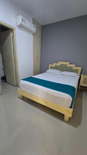 a bedroom with a large bed with a wooden frame at Hotel Med Barranquilla Centro in Barranquilla