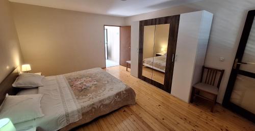 a small bedroom with a bed and a mirror at Room Julija first row on see with wiew in Brna