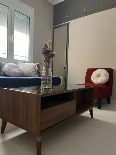 a living room with a coffee table and a couch at Piccadilly Apartment Patras in Patra