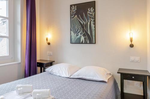 Ένα ή περισσότερα κρεβάτια σε δωμάτιο στο Hôtel Patricia - Strasbourg Hyper Centre