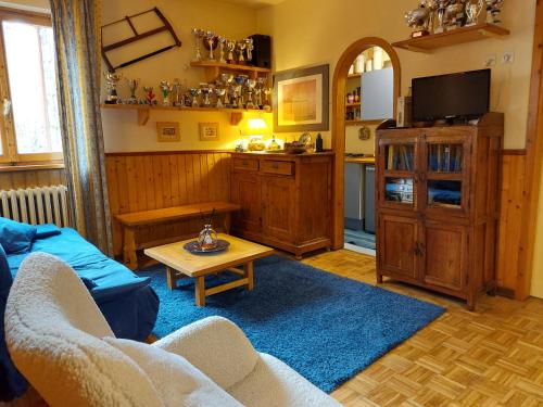 a living room with a couch and a table at Residenza Zeno Abetone in Abetone