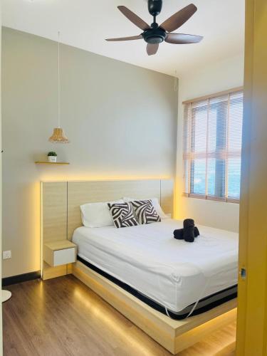 a bedroom with a bed with a ceiling fan at Vista Bangi Muji-styled 3BR Sunrise view in Kajang