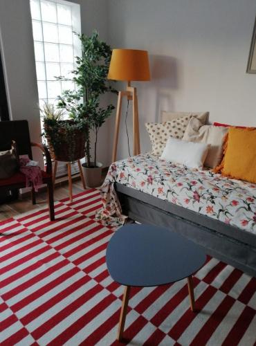 a bedroom with a bed and a red and white rug at ELEVEN -A- SUITE tipo T1 in Mértola
