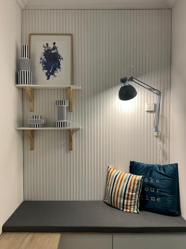 a room with a bench with a lamp and a pillow at Relax, sea and mountains in A Guarda
