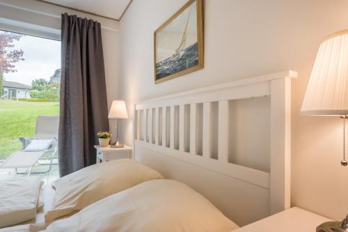 a bedroom with a bed and a window at Hotel-Restaurant Nordlicht in Kappeln