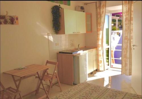 a small kitchen with a table and a table and a table and a table at PonzaSmeralda Le Forna in Ponza