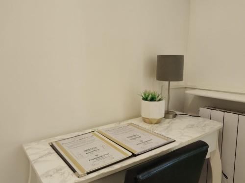 a desk with two books on it with a chair at Hotel Birillo in La Spezia