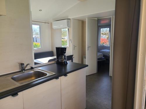 a kitchen with a sink and a counter top at Mobile home in Talmont
