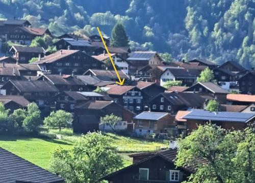 a wind turbine flies over a village at Gadänäscht in Jenaz