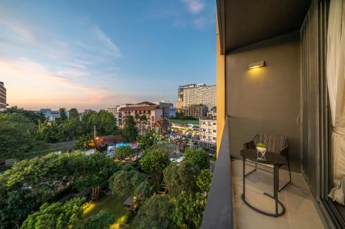 a balcony with a table and a view of a city at Vacaystation Edge Central Pattaya in Pattaya Central