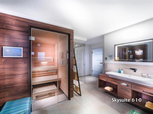 a bathroom with a large shower and a sink at Strandhotel Duhnen in Cuxhaven