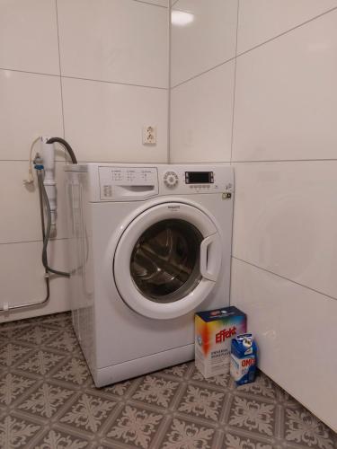 a washing machine in a corner of a room at Cozy Apartment with Reinebringen Mountain View - Reine, Lofoten in Reine