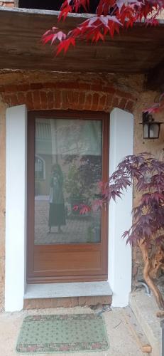 a person standing in a window of a house at Albaluna 2 casa vacanza in Dronero