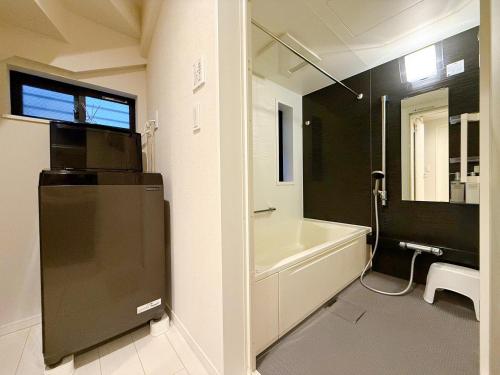 a bathroom with a white tub and a sink and a toilet at Tabi in Tokyo in Tokyo