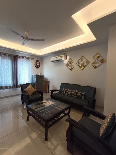a living room with a couch and a table at 2BHK Flat Rishikesh Ganga Bhumi- Kaphal Nest in Rishīkesh