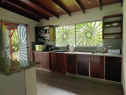 a kitchen with stained glass windows and a kitchen counter at Villas Kiki in Puerto Viejo