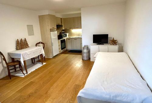 a small room with a bed and a kitchen at La boille in Villars-sur-Ollon