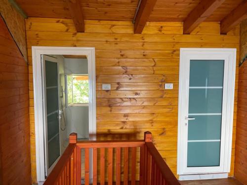 a porch of a wooden house with a door at Villa Tomorrow in Ujanik