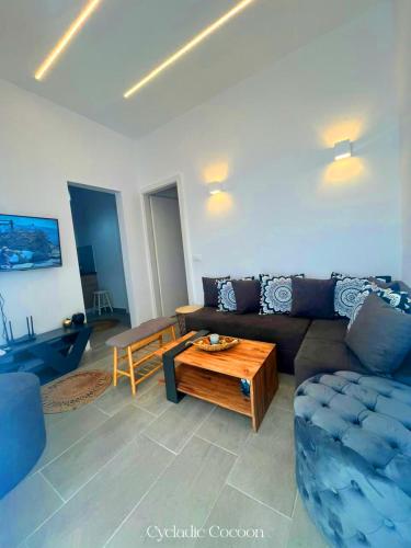 a living room with a couch and a coffee table at Cycladic Cocoon Mykonos Town in Megali Ammos