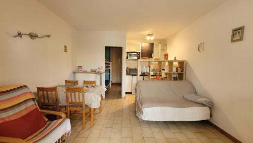 un salon avec un lit, une table et des chaises dans l'établissement Studio Les Lecques 100m de la plage, à Saint-Cyr-sur-Mer