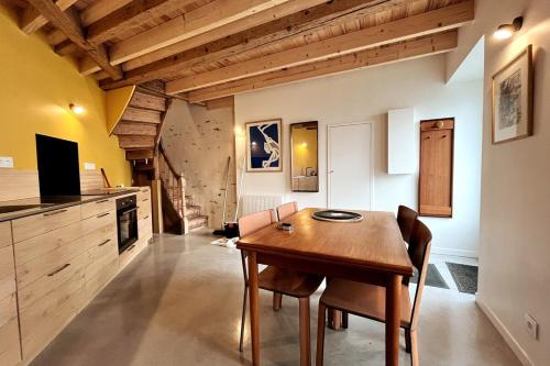 une salle à manger avec une table et des chaises en bois dans l'établissement La Maison Rouge sur le port à proximité de toutes commodités 2 personnes, à Plérin