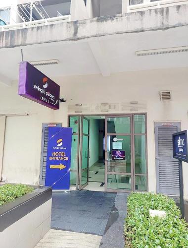 an entrance to a building with a revolving door at Swing & Pillows - Z Hotel Cyberjaya in Cyberjaya