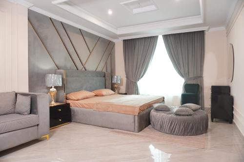 a bedroom with a bed and a chair and a couch at Bhurban Homes in Murree