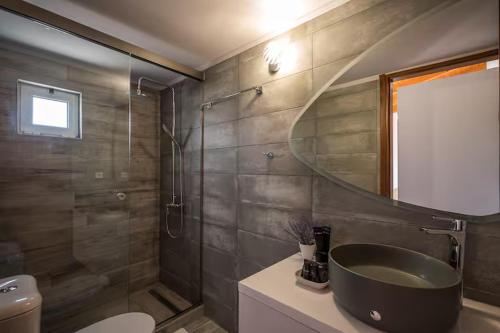 a bathroom with a sink and a shower at Irene Apartment in Néa Alikarnassós
