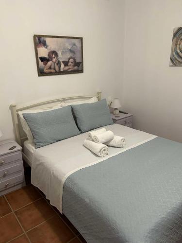 a bedroom with a bed with towels on it at Villa Evdokia II in Makry Gialos