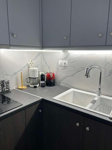 a kitchen with a sink and a counter top at Villa Evdokia II in Makry Gialos