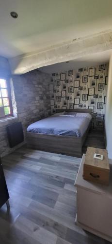 une chambre avec un lit dans une pièce dans l'établissement la maison du hobbit, à Flamets-Frétils