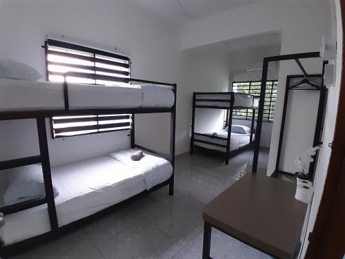 a room with two bunk beds and a mirror at Lakefront Homestay in Taiping
