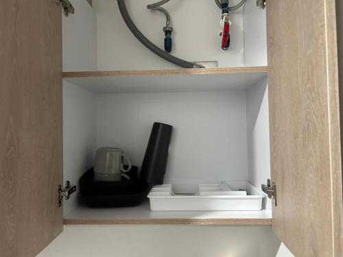 a cupboard with a coffee maker and a blender at New Oceanfront Apartment in Mazatlán