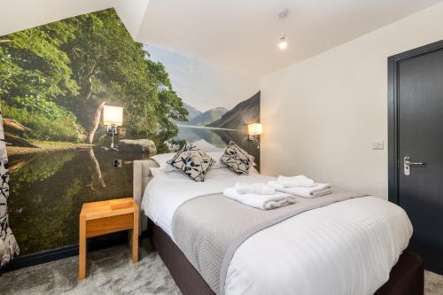 a bedroom with two beds with a painting on the wall at The Kellbank in Gosforth
