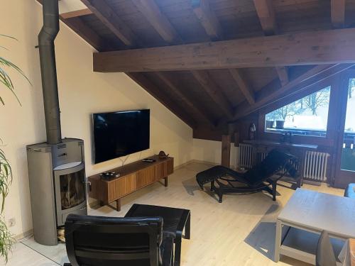 a living room with a fireplace and a television at Lauterbrunnen Staubbach Amazing Waterfall View in Lauterbrunnen