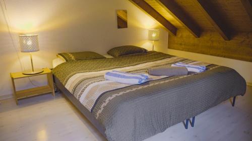 a bedroom with a large bed with two towels on it at Lauterbrunnen Staubbach Amazing Waterfall View in Lauterbrunnen