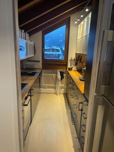 a large kitchen with a large window in it at Lauterbrunnen Staubbach Amazing Waterfall View in Lauterbrunnen