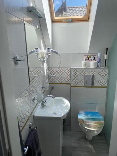 a small bathroom with a sink and a toilet at Palanga Cozy Studio in Palanga