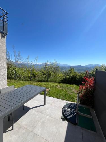 a picnic table on a patio with a view at Villa Côté Charance Pelleautier in Pelleautier