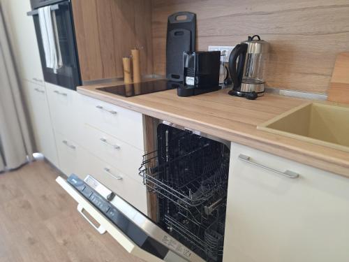a kitchen with a counter top with a dishwasher at Skyline studio 44 in Varna City